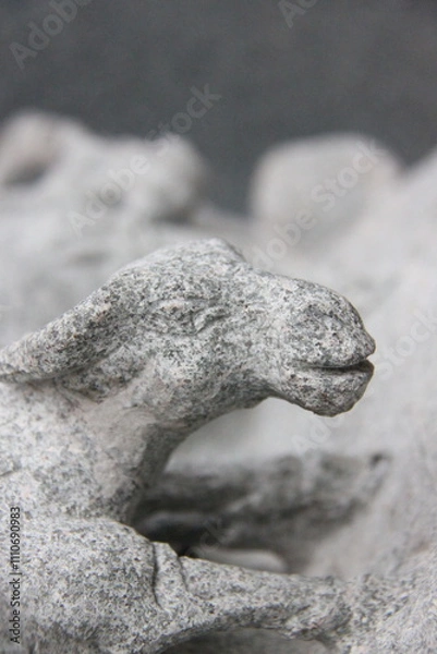 Obraz detail of a stone sculpture of a goat in a park, close up