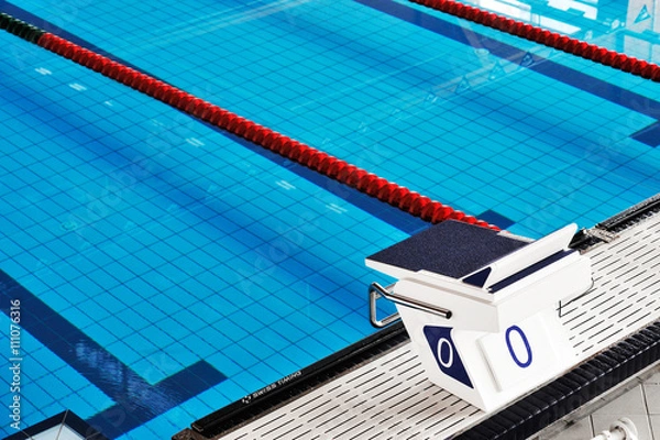 Fototapeta Starting blocks and lanes in a swimming pool