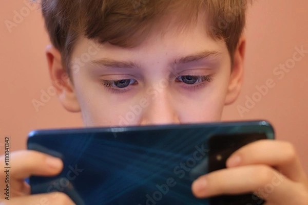Obraz Close-up of a teenager's eyes staring at a smartphone