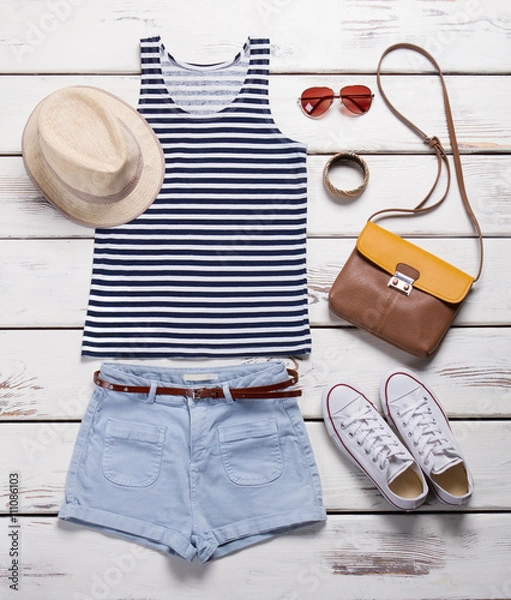 Obraz Light shorts with striped top. Girl's summer outfit on showcase.