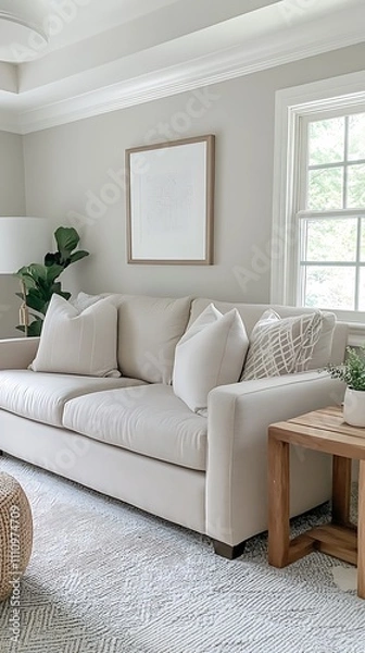 Fototapeta Living room with a gray fabric sofa, wooden side table, and a white ceiling lamp