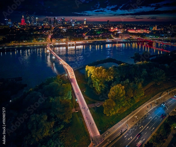 Obraz Beautiful panoramic aerial drone night sunset view to the new pedestrian and bicycle bridge connecting the banks of the Vistula, Warsaw, Poland.