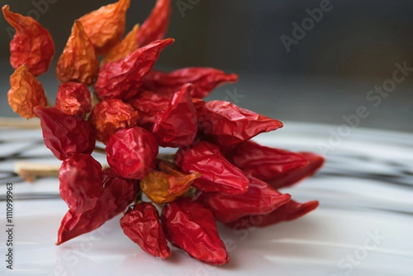 Obraz Dry red chili pepper, tied in a rope to ripen.
