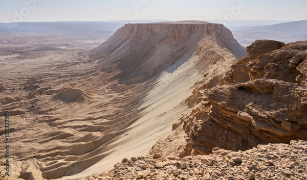 Fototapeta A path on the ridge of Mount Zin or Har Zin in Har Hahar nature reserve in the the Negev Desert. Unique landscape of the mount - a top like flat table. Tourist in a hiking trail. Active lifestyle.