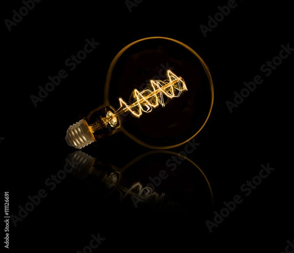 Fototapeta Lightbulb on black background with nice reflection