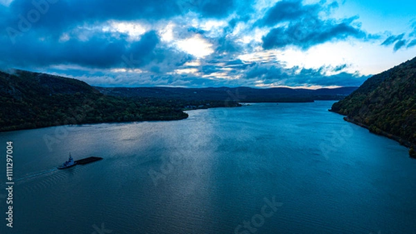 Fototapeta 10/14/22 WEST POINT, NY, USA - drone view of Barge going down Hudson River at dawn near Storm King State Park off 9W North of NY City, Hudson River Valley