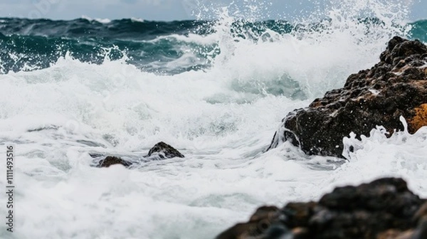 Fototapeta Raging ocean waves crashing against rocky shore, creating a dynamic and dramatic seascape.