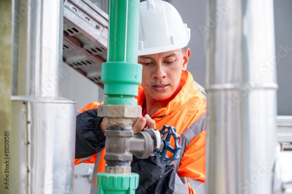 Obraz The image captures a skilled engineer inspecting a network of pipelines in a petrochemical facility. the concept of projects related to petrochemicals, engineering, and industrial inspection.