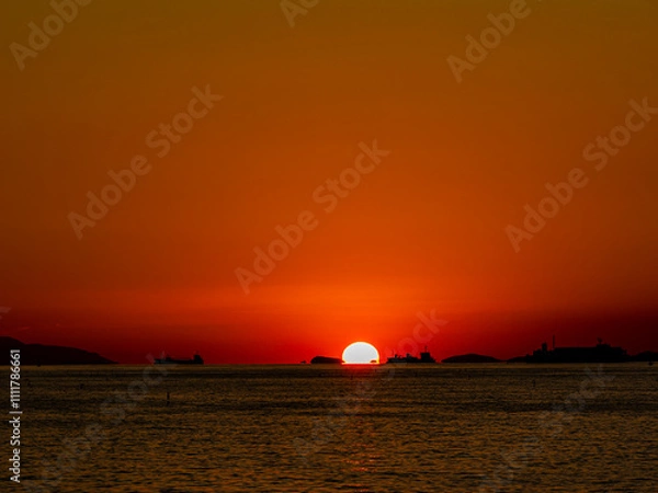 Obraz 海に沈む秋の夕日