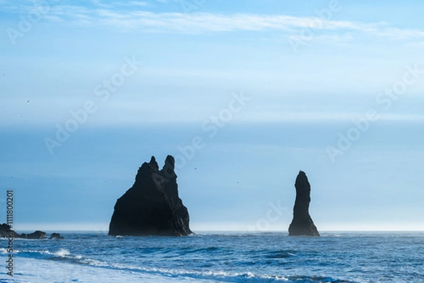 Fototapeta Reynisfjara black sand beach in Iceland. Ocean cliffs. Sunny day. Seascape. Touristic place.