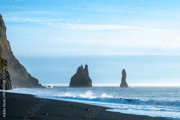 Fototapeta Reynisfjara black sand beach in Iceland. Ocean cliffs. Sunny day. Seascape. Touristic place.