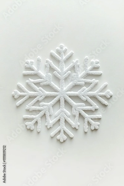 Fototapeta A textured white snowflake design on a light background.