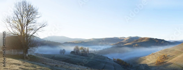 Fototapeta Small cottage in the mountains-panoramic view