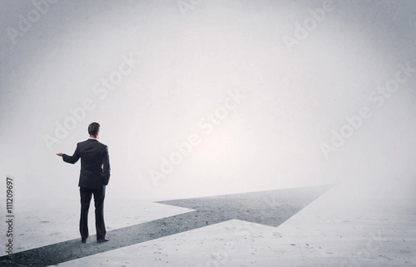 Fototapeta Standing salesman looking ahead with arrow