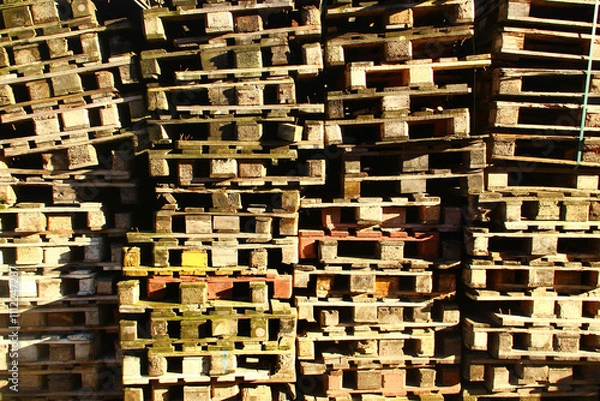Fototapeta Stacks of wooden pallets in a warehouse