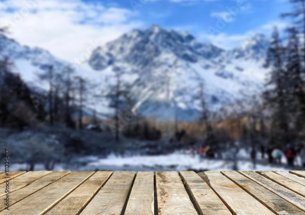 Obraz Wooden table top on blurred background mountains and forest nature Snow for important product editing or image layout design. View of the copy space.