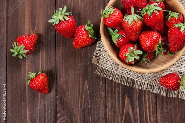 Obraz Fresh strawberries on an old wooden surface.