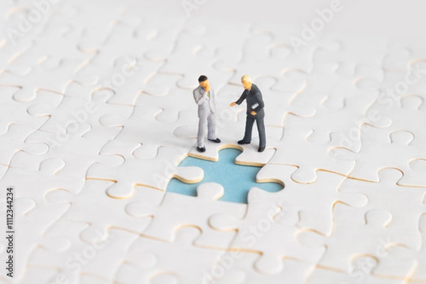 Fototapeta Miniature people looking for a jigsaw puzzle solution to a missing piece problem.