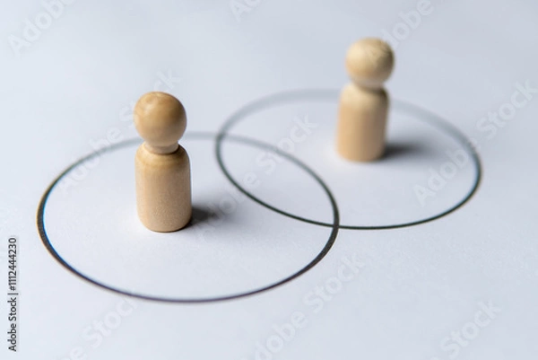 Obraz Two wooden figures standing in separate circles overlaps with each other. Consensus and agreement concept.