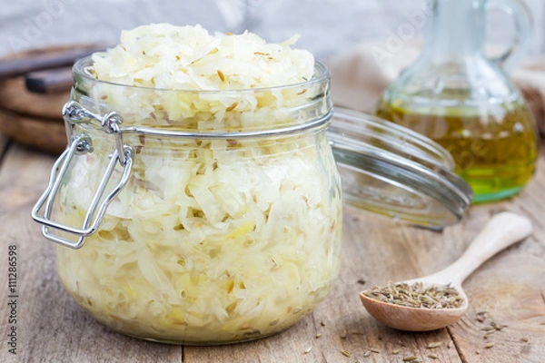 Obraz Homemade sauerkraut with cumin in a glass jar 