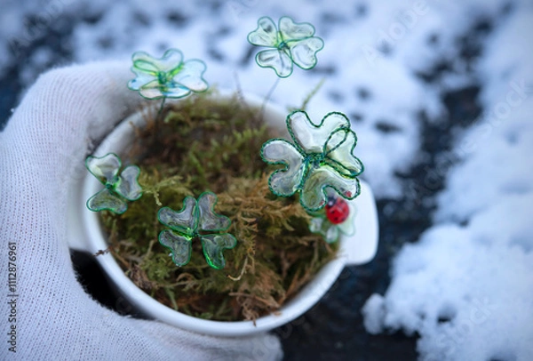 Obraz Hand Holding white Pot with Four-Leaf Clovers and Ladybug - Handmade Decoration. Symbol for good Luck in New year.