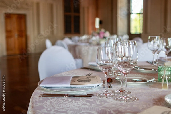 Fototapeta A beautifully arranged table with glassware and napkins, perfect for formal gatherings or celebrations