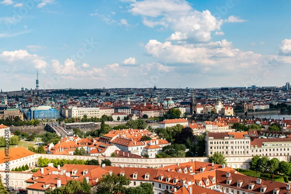Fototapeta A vibrant view of Prague’s architecture, bridges, and skyline from Prague Castle on a sunny day.
