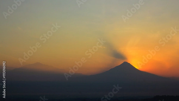 Fototapeta Silhouette of Mount Merapi with a red-orange sky at sunrise. The volcano is a Stratovolcano type of eruption, located in Yogyakarta and Central Java