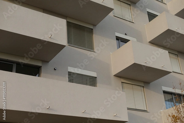 Fototapeta There exists a large building characterized by its numerous windows and a variety of balconies, creating an impressive facade