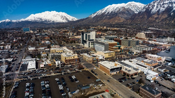 Fototapeta MARCH 2024, PROVO, UTAH - Provo Skyline and main street area is surrounded by snow capped Wasatch Mountains