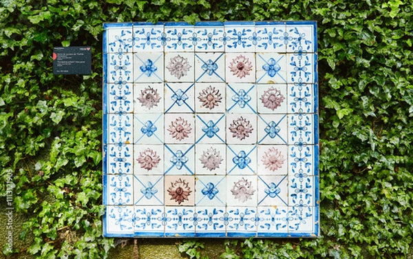 Fototapeta Fragment of building wall with colorful ceramic wall tiles Azulejo