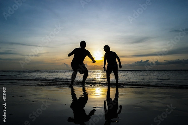 Obraz boys jumping on the beach Sunset
