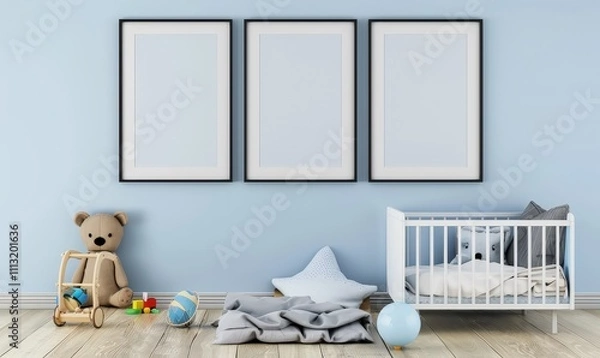 Fototapeta Empty frames above a crib in a blue and white nursery with toys