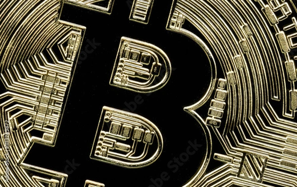 Fototapeta Stunning image of a golden bitcoin. Capturing the intricate details of the iconic cryptocurrency.  Perfect for financial marketing or tech content.