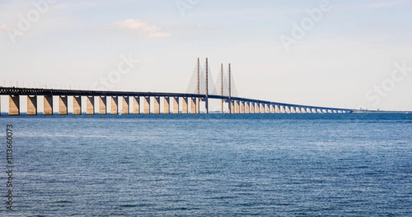 Fototapeta Panoramic view of the Oresund bridge, a railway and motorway cable-stayed bridge across the Oresund strait between Denmark and Sweden, seen from the swedish shore.