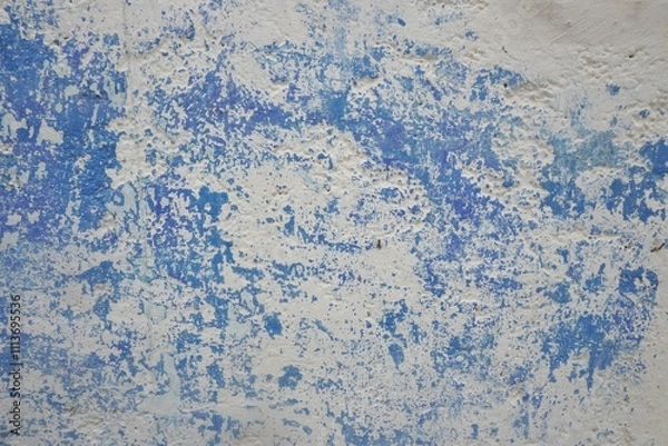 Fototapeta Abstract blue and white background pattern with scratched and chipped blue paint over chalky white wall