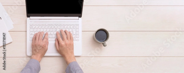 Obraz A ｍan using a laptop PC. ノートパソコンを使う男性。