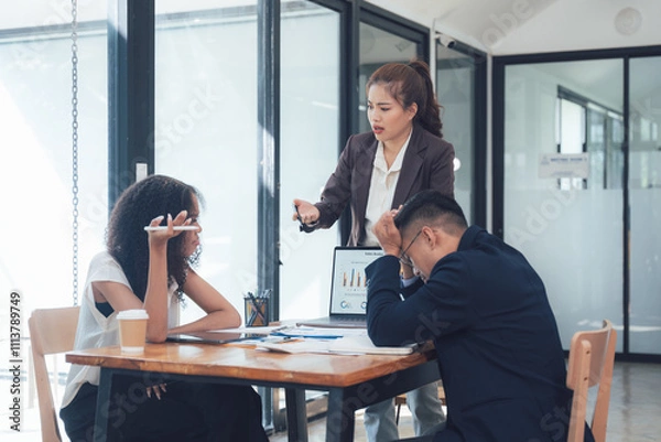 Fototapeta The Pressure's On: A tense moment in a corporate setting, where a frustrated manager confronts a struggling team.  The image reflects the stresses and challenges faced by modern professionals.