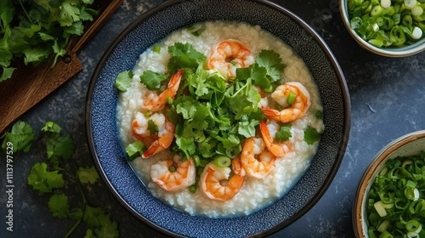 Fototapeta A vibrant, colorful display of shrimp rice porridge topped with cilantro and scallions, highlighting the dish fresh ingredients and inviting presentation