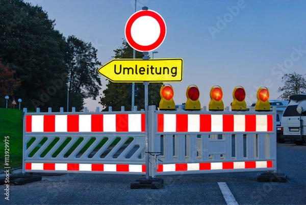 Fototapeta Roadworks illuminated by headlights at dusk with detour signs and flashing lights. - 2338