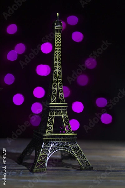 Fototapeta Eiffel tower shot in studio with bokeh lights in backgound