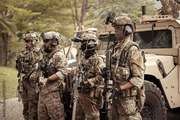 Fototapeta United States Army in camouflage uniforms operation in the forest.with armored vehicle, soldiers training  in a military operation