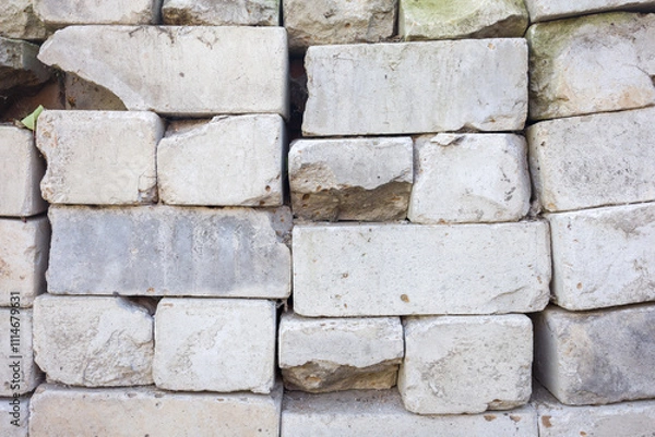 Obraz Weathered stone wall texture. Irregular blocks, showing age and damage. Great for background or design.