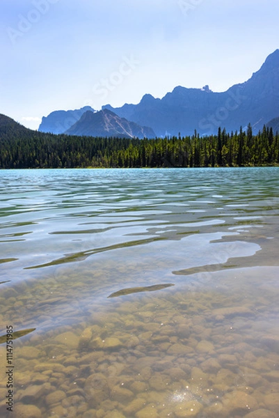 Fototapeta clear lake in the mountains between Banff and Jasper Alberta Canada on sunny summer day