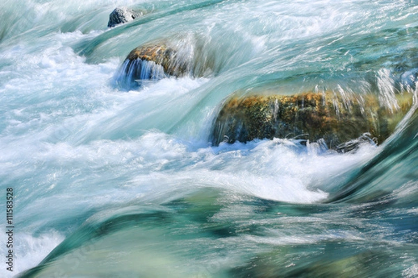 Fototapeta Mountain stream flowing over rocks.