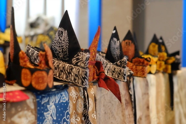 Obraz An array of Indonesian batik shirts and batik cloth hangs on the racks, displaying a variety of patterns and colors.