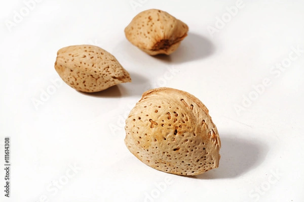 Obraz three almonds on the white background isolated