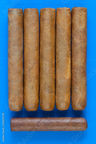 Fototapeta Detail of luxury Cuban cigars on the blue desk