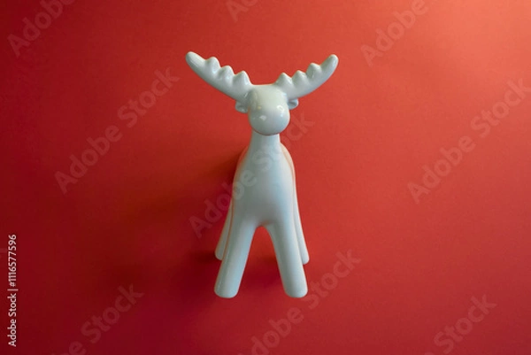 Obraz A Stylish White Moose Figurine Set Against a Bright Red Background to Enhance Its Appeal