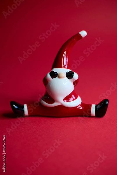 Obraz This charming and festive Santa figurine is designed in a playful pose that radiates holiday cheer
